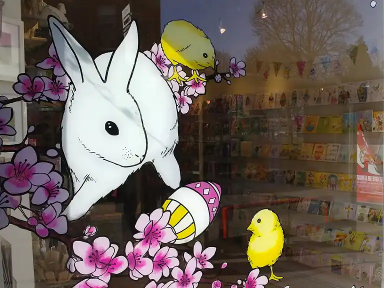 Hand-painted commercial shop window with rabbit and chicks for an Easter display by mural artist David Jimenez in Edinburgh