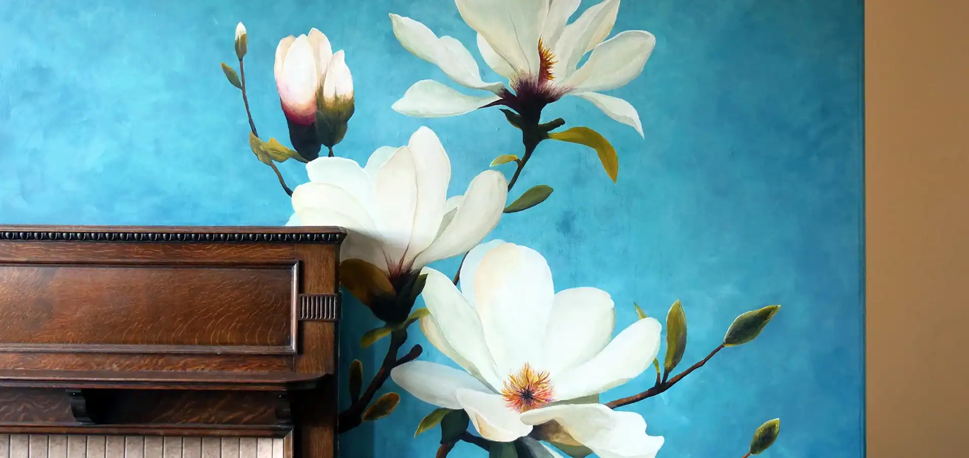 White floral mural on blue wall above a fireplace in an Edinburgh home