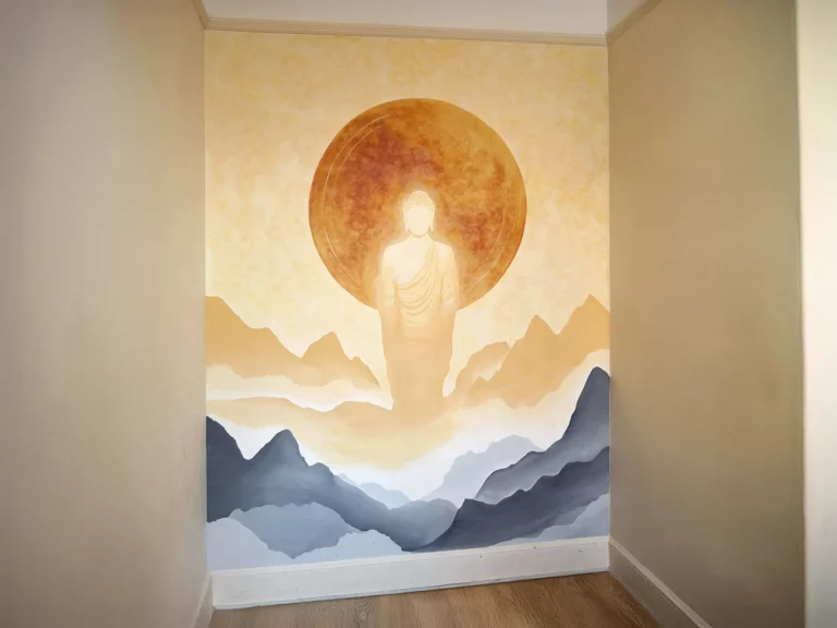 Hand-painted interior wall mural of a Buddha in earth tones for a meditation room