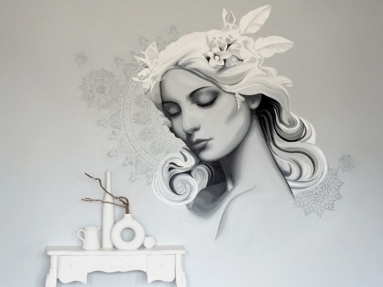 A mural painting of a woman in subtle grey tones